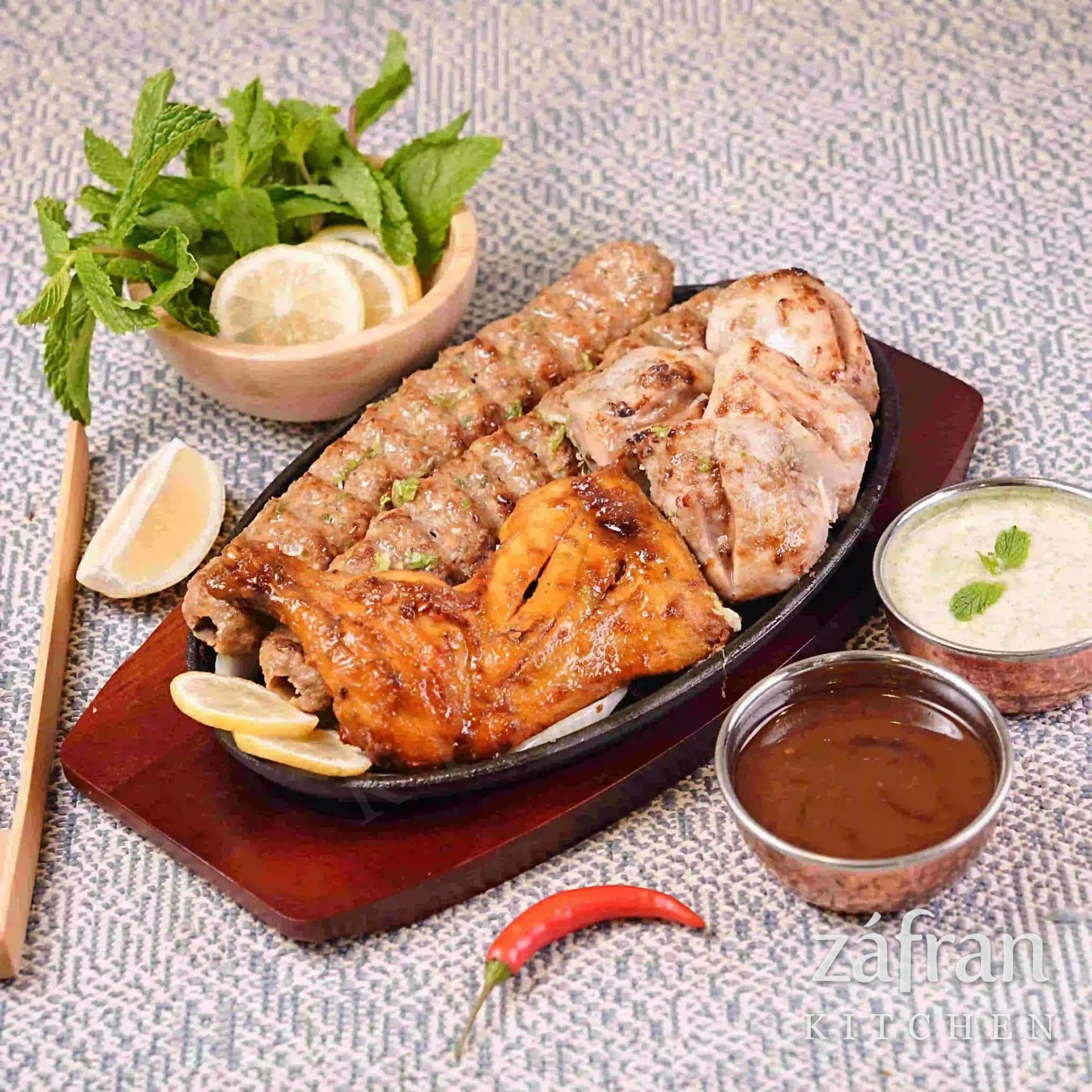 Mixed BBQ platter of seekh kabab, boti and grilled chicken at Zafran Kitchen Ajman