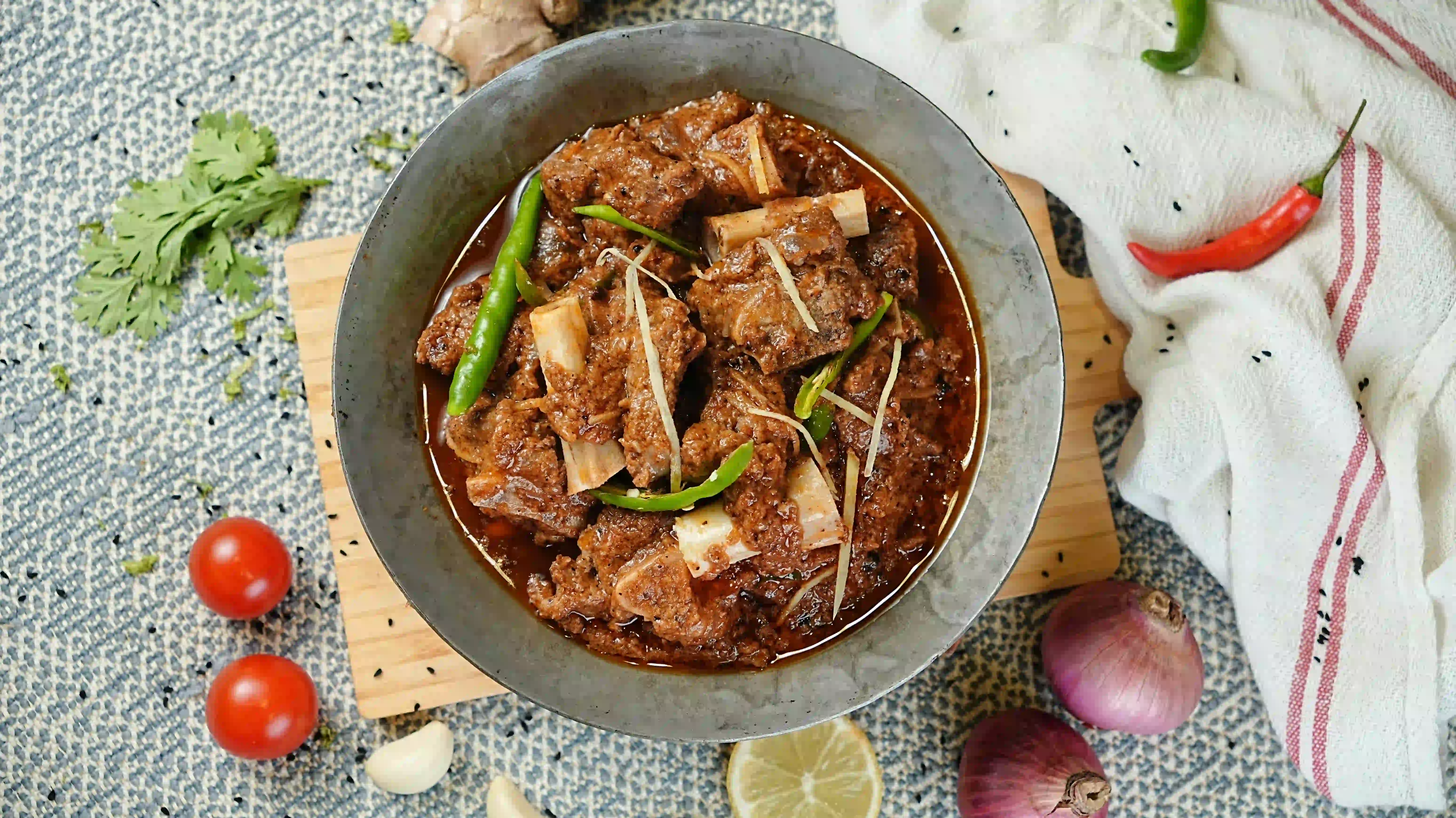 Mutton Charsi karahi being finished with black pepper and coriander at Zafran Kitchen, Ajman