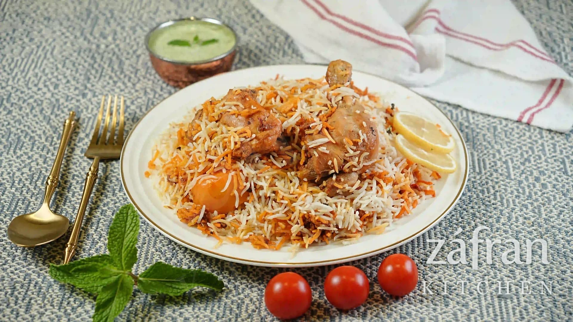 Chicken biryani plated with raita at Zafran Kitchen, Ajman Industrial Area 2